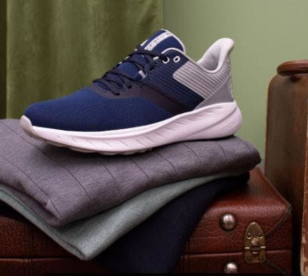 Side view of navy and white Footjoy golf shoes.